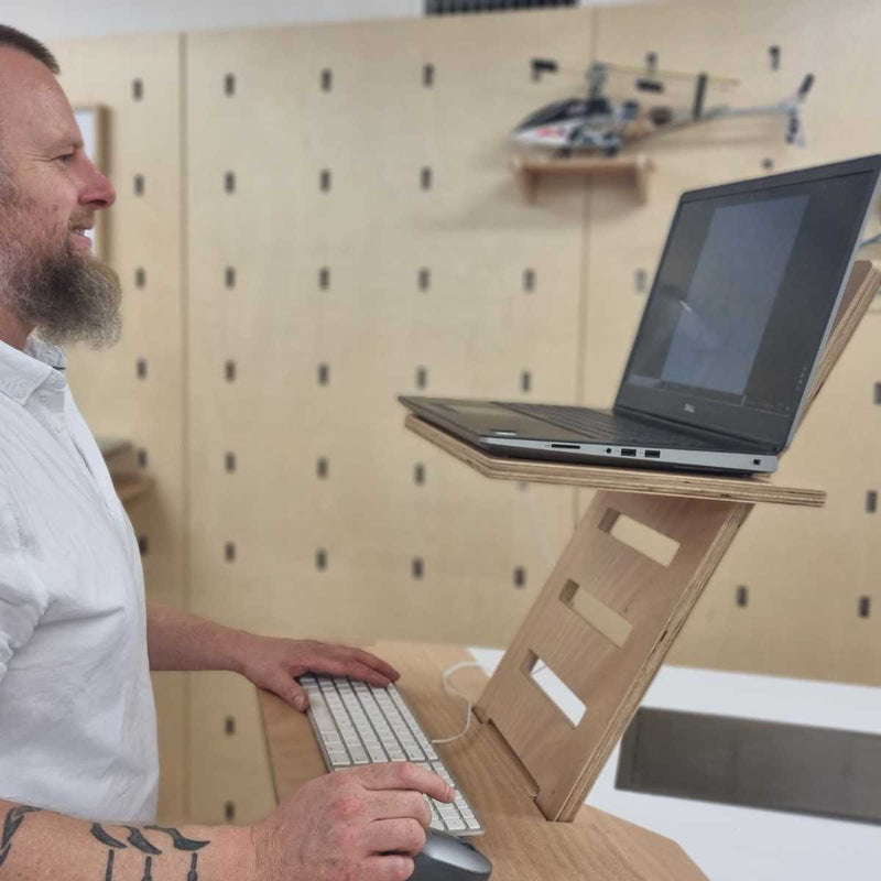 David Crout using The Desk Stars Laptop Stand on a kitchen top, demonstrating laptop height and keyboard set-up